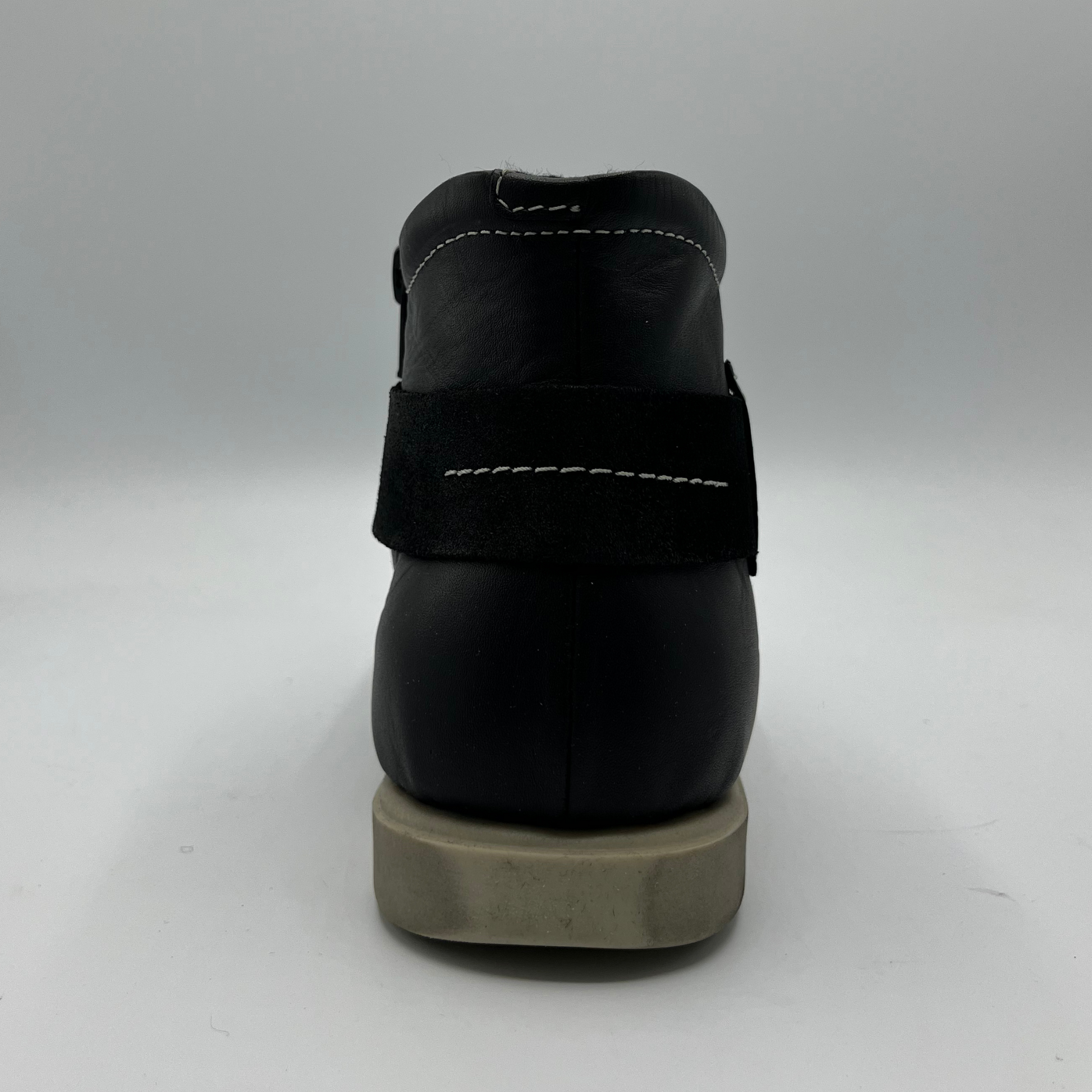 Black shoe with a thick sole on a white background