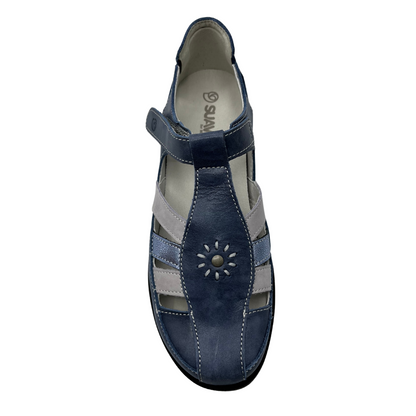 Top view of blue leather shoe with white and blue metallic straps