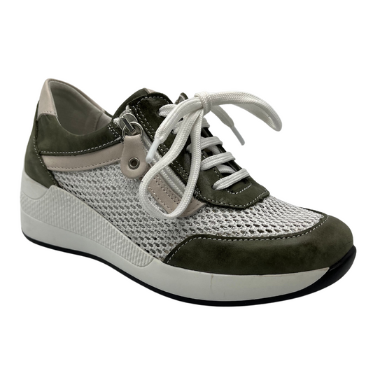 45 degree angled view of women's wedge sole sneaker with white laces and side zipper