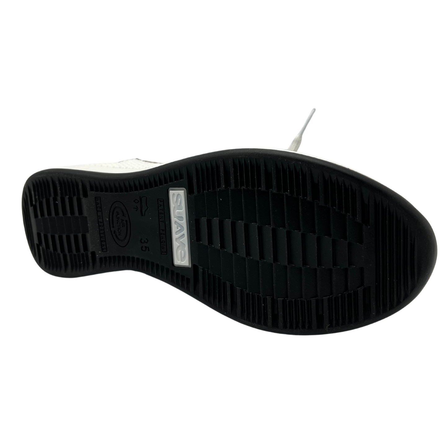 Bottom view of women's wedge sneaker with black and white rubber outsole