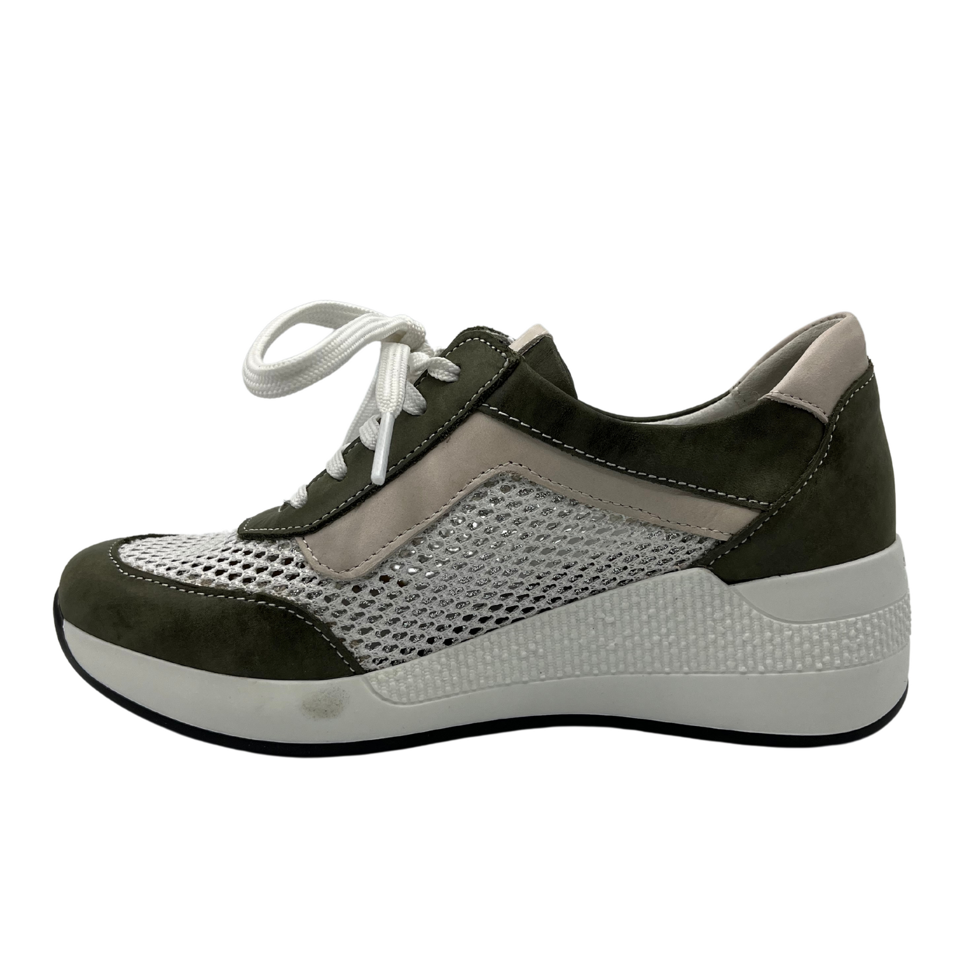 Left facing view of women's wedge sneaker with white laces, mesh sides and white rubber outsole