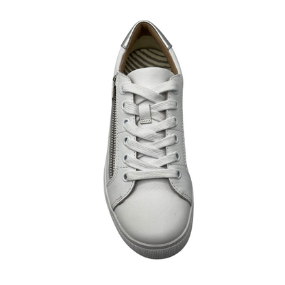 Top view of white leather sneaker with rounded toe, side zipper closure and matching laces