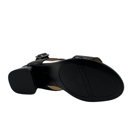 Bottom view of black patent sandal with block heel