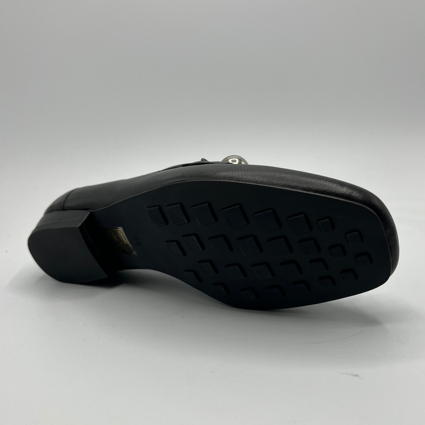 Black shoe sole on a gray background