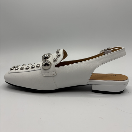 White shoe with decorative elements on a gray background