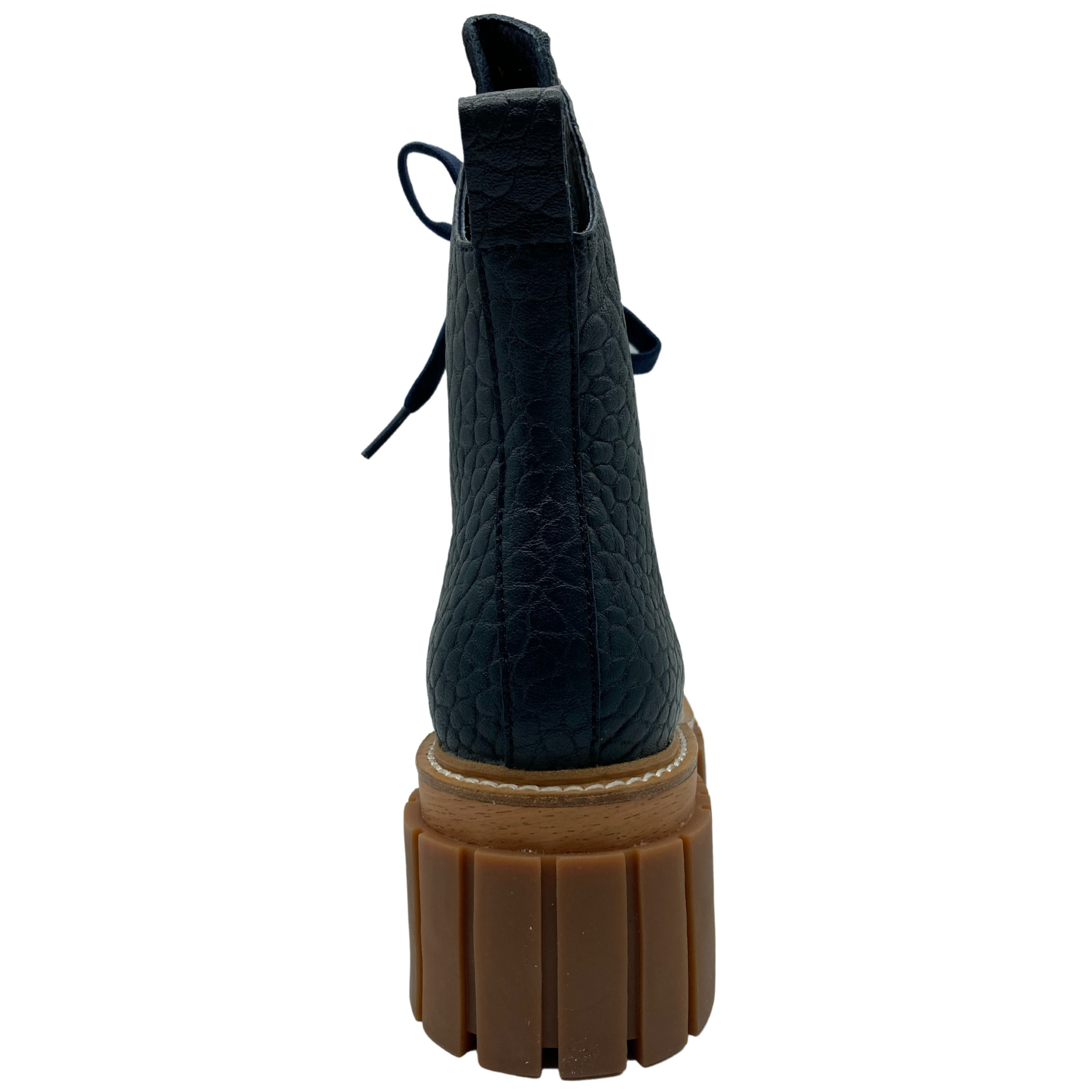 Heel view of textured navy leather boot with chunky brown rubber outsole
