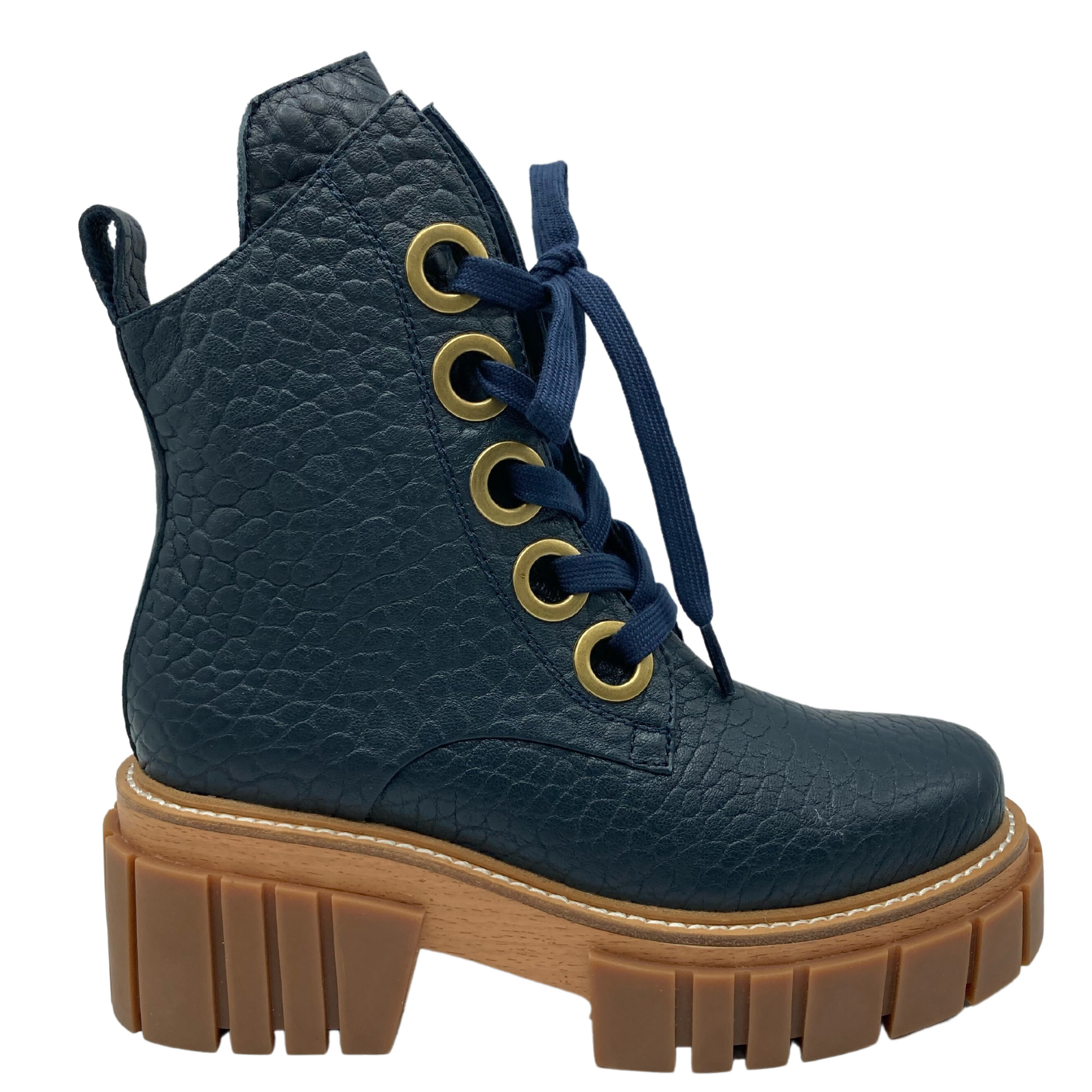 Right facing view of navy textured leather boot with chunky brown rubber outsole and navy laces 