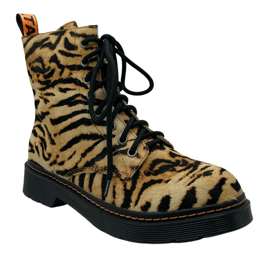 45 degree angled view of tiger print leather combat boot with black laces and black outsole