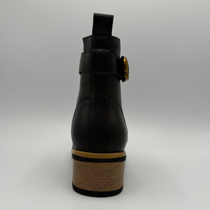 Back view of a leather short boot with a brown stacked heel