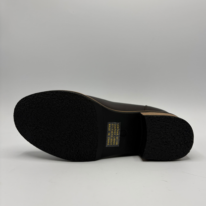 Bottom view of a leather short boot with a brown stacked heel
