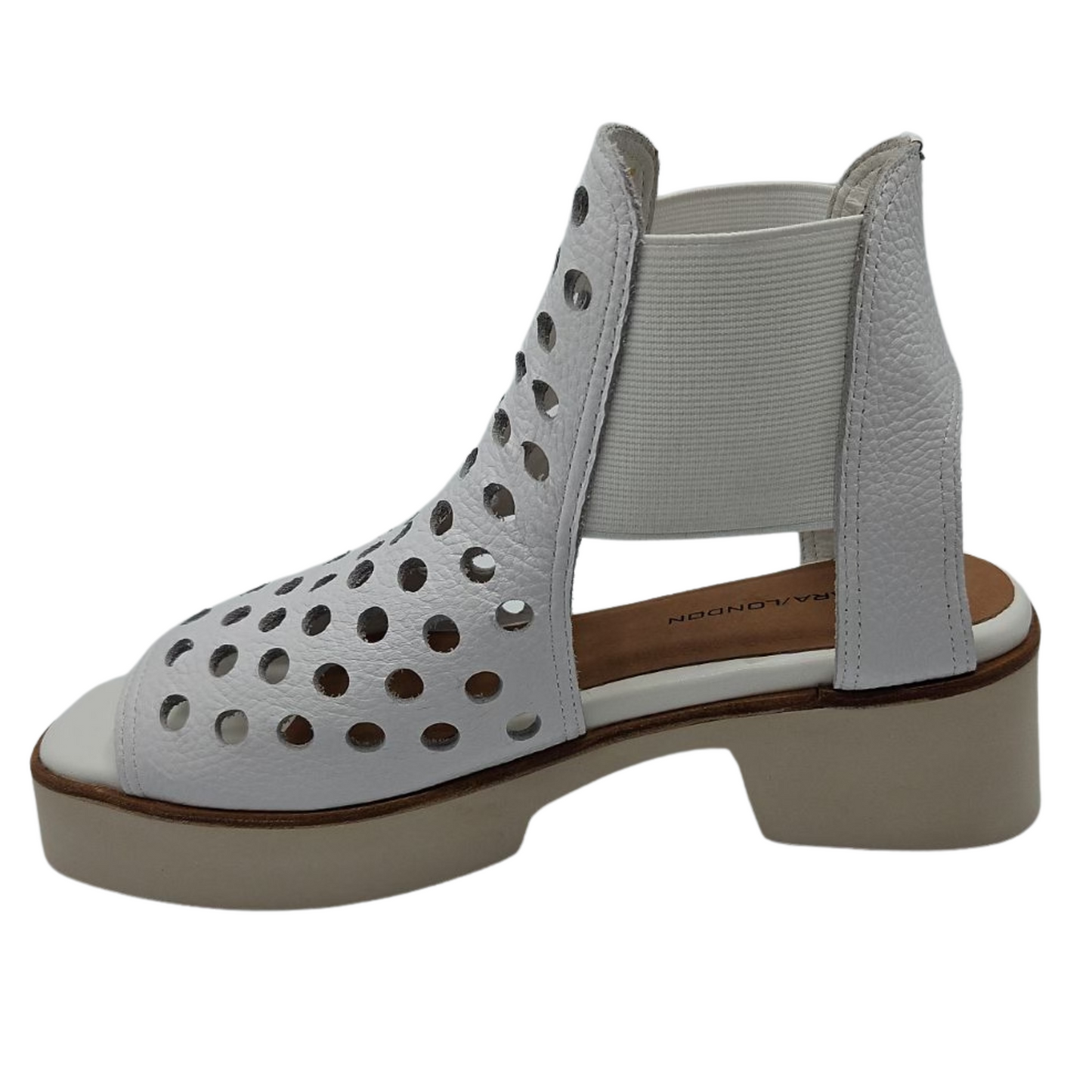 Left facing view of white perforated leather sandals with elastic sides and platform sole