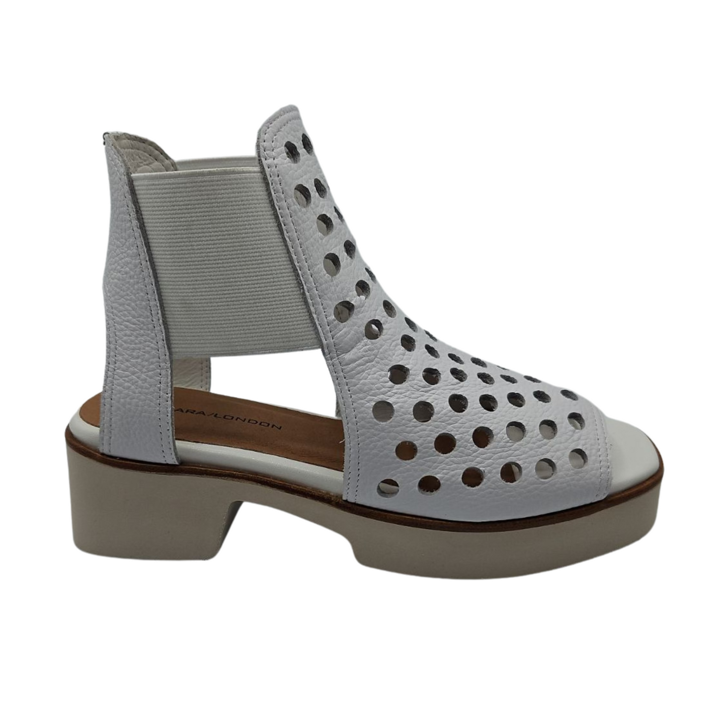 Right facing view of white perforated leather sandals with elastic sides and platform sole