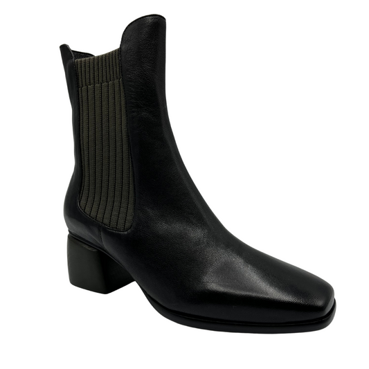 45 degree angled view of black olive leather short boot with sock knit side gore, block heel and slightly squared toe