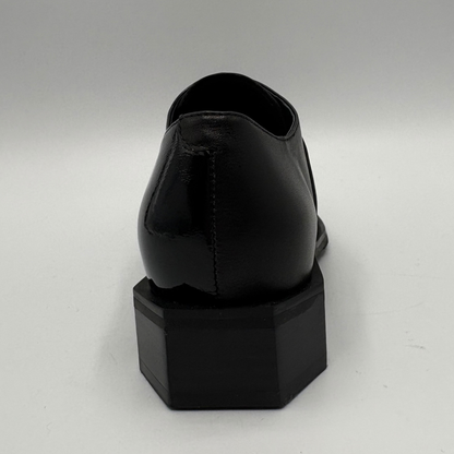 Back view of a black shoe with a geometric heel