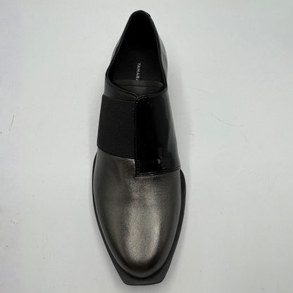 Top view of a black shoe with a geometric heel