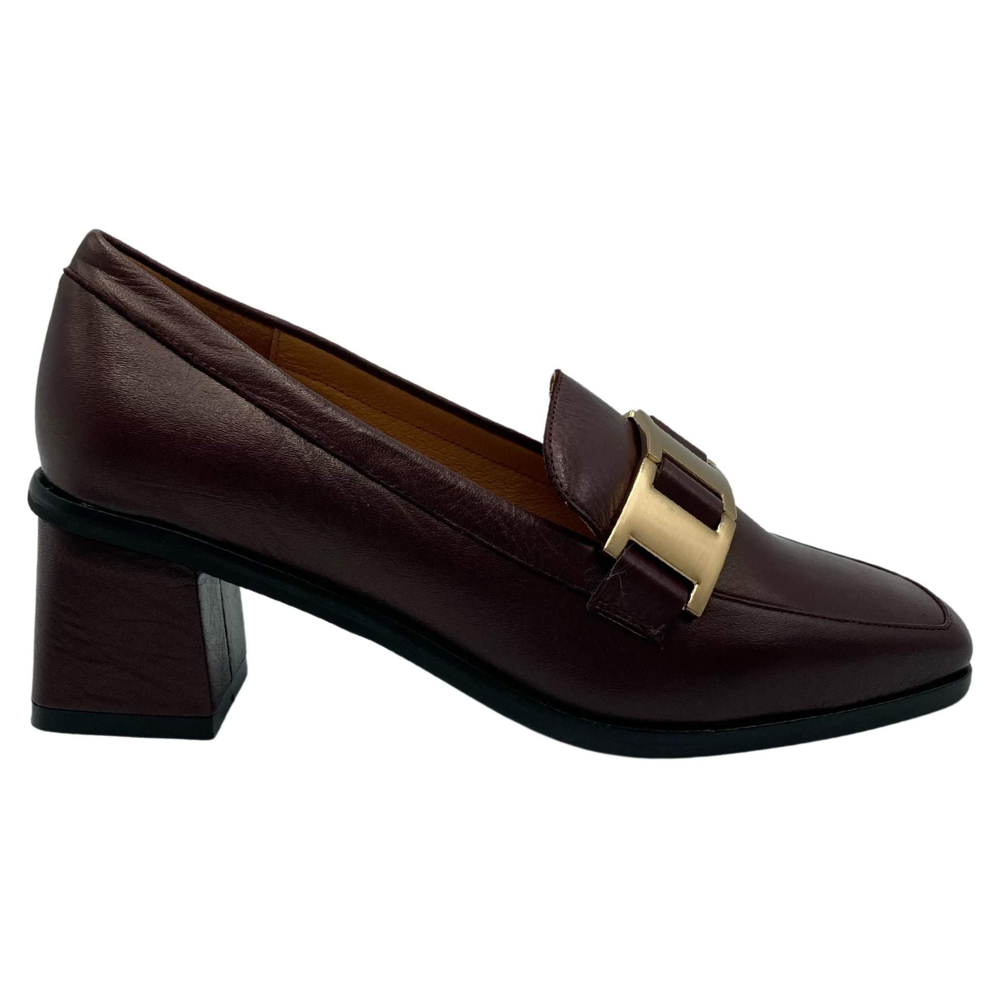 Right facing view of wine coloured loafer with gold buckle detail on upper and block leather covered heel