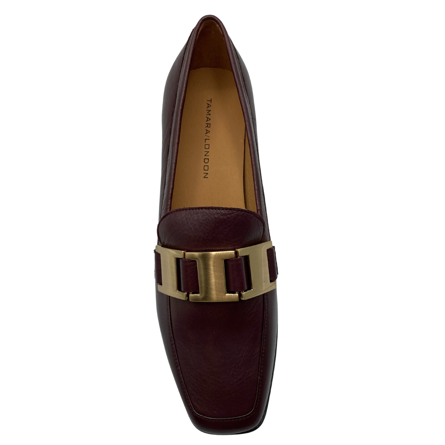 Top view of leather loafer with square toe and gold buckle detail on upper. 