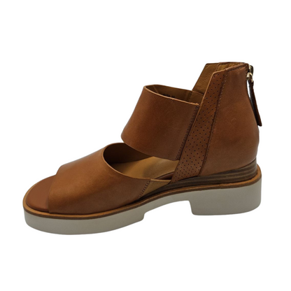 Left facing view of brown leather sandals with back zipper closure, white platform sole and open toe