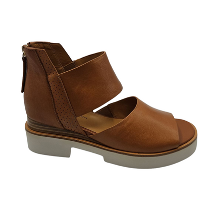 Right facing view of brown leather sandals with back zipper closure, white platform sole and open toe