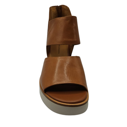 Front view of brown leather sandals with back zipper closure, white platform sole and open toe
