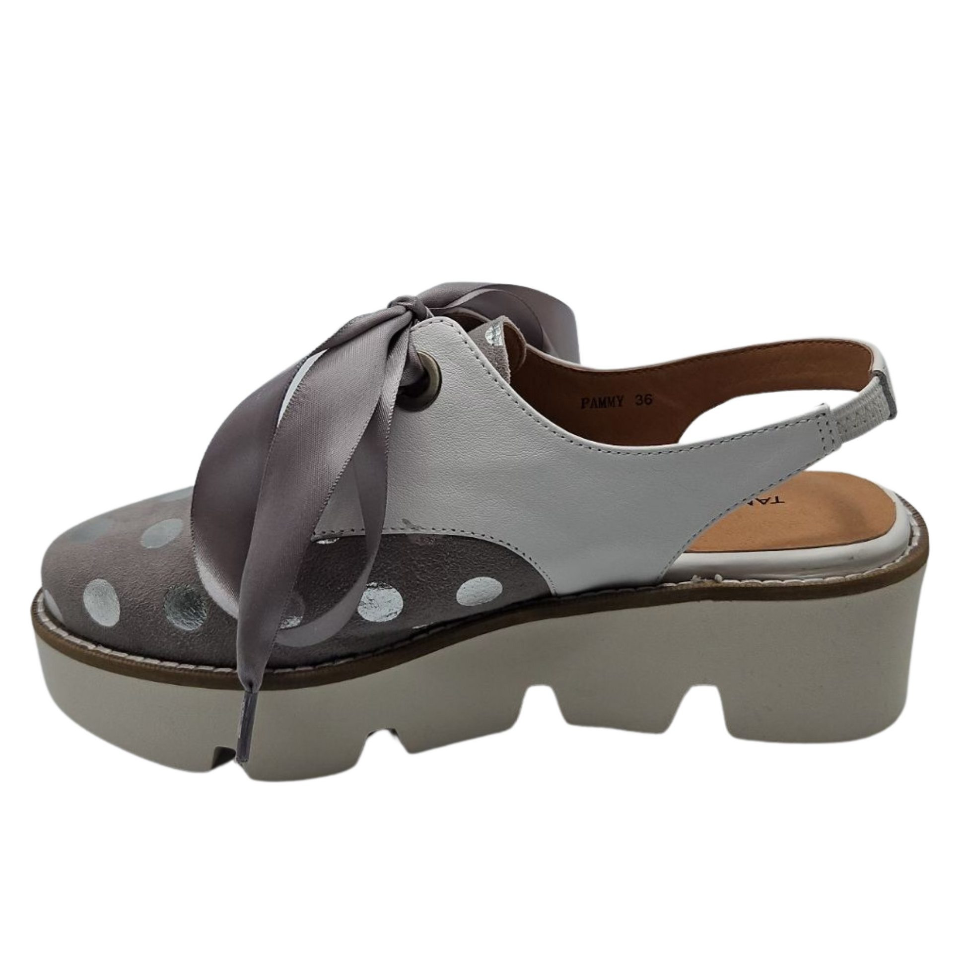 Left facing view of dove grey suede oxfords with shiny silver polka dots. Featuring satin ribbon laces, slingback strap and chunky white platform sole.
