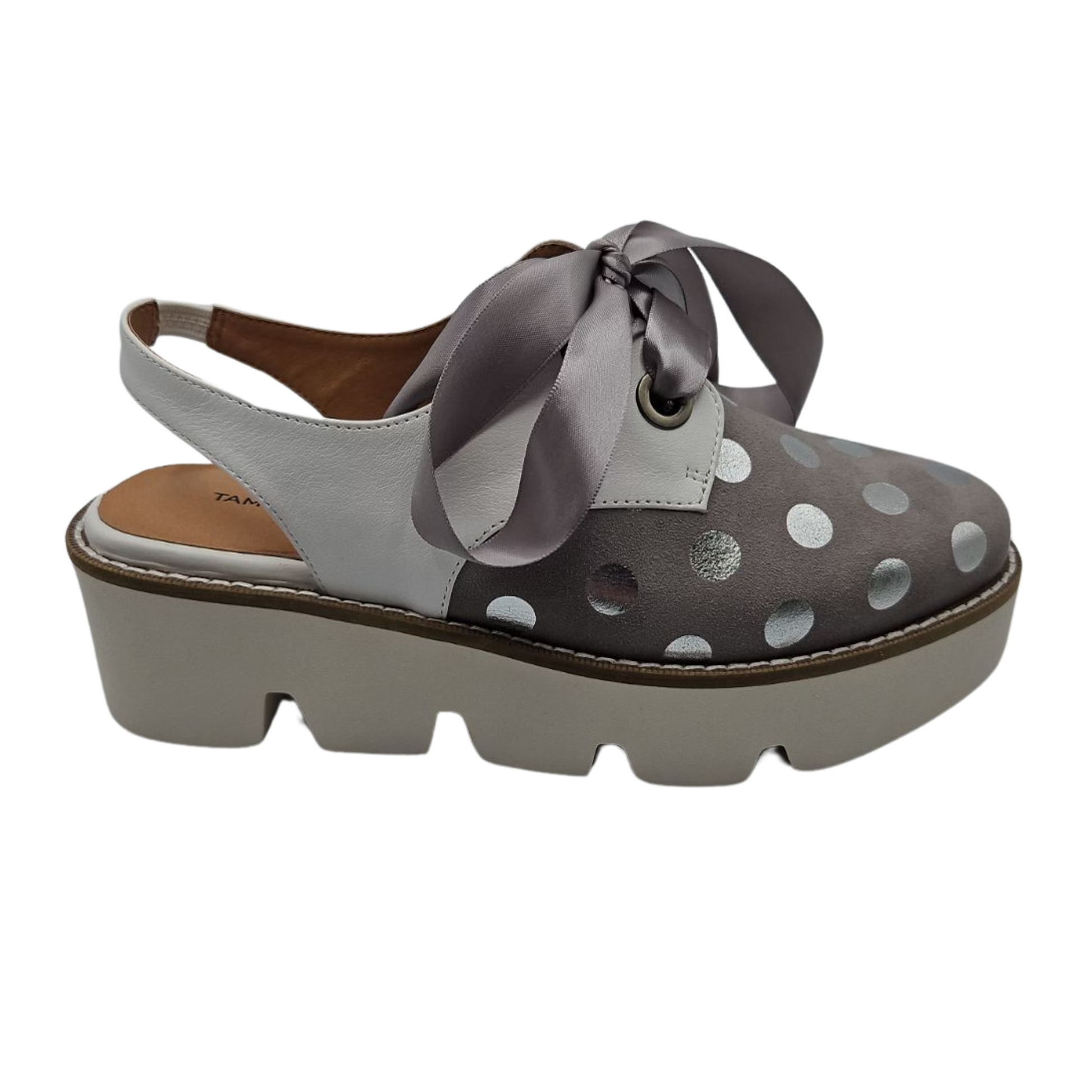 Right facing view of dove grey suede oxfords with shiny silver polka dots. Featuring satin ribbon laces, slingback strap and chunky white platform sole.