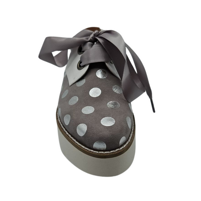 Front view of dove grey suede oxfords with shiny silver polka dots. Featuring satin ribbon laces, slingback strap and chunky white platform sole.