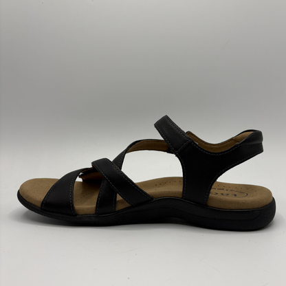 Black sandal with a tan insole on a white background