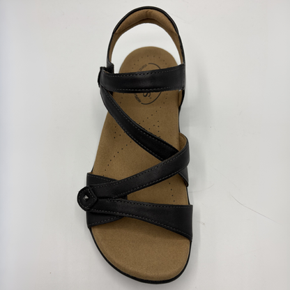 Black sandal with a brown sole on a white background