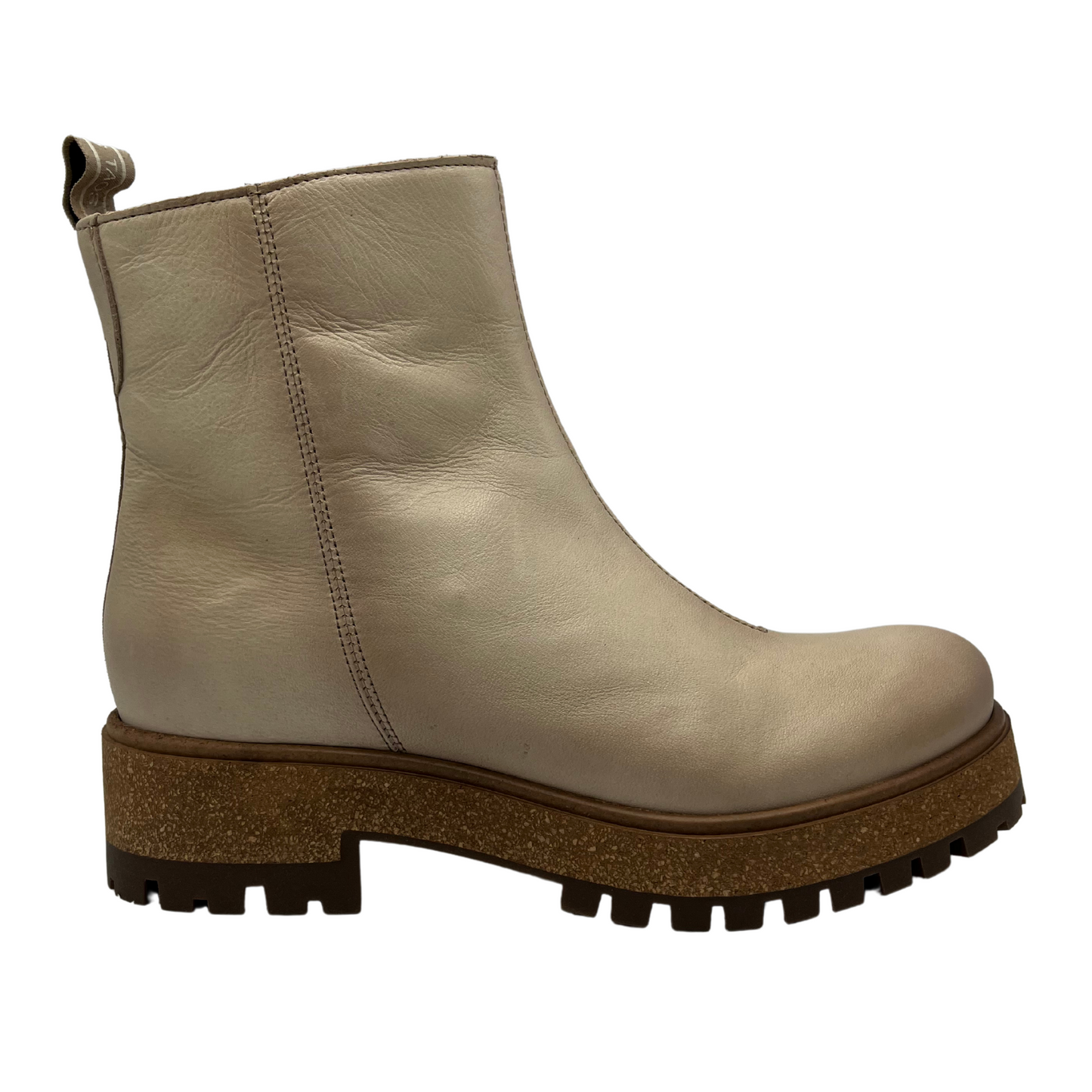 Right facing view of ivory leather short boot with rubber and cork outsole with inner zipper closure and pull on tab