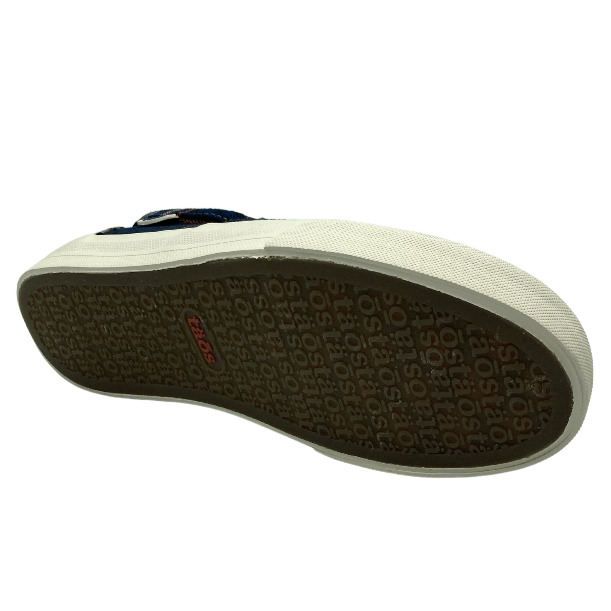 Bottom view of slip on shoe with brown rubber sole with white border