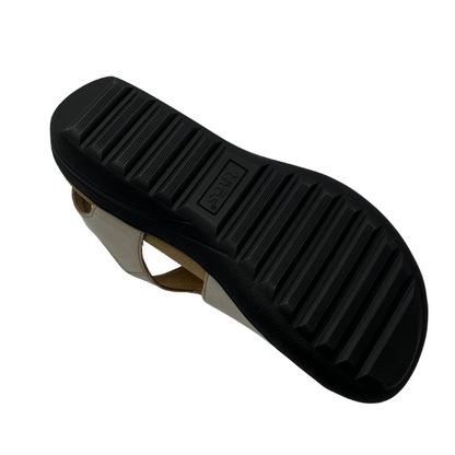 Bottom view of leather sandals with hook and loop closure straps, cushioned collar and leather lined footbed.