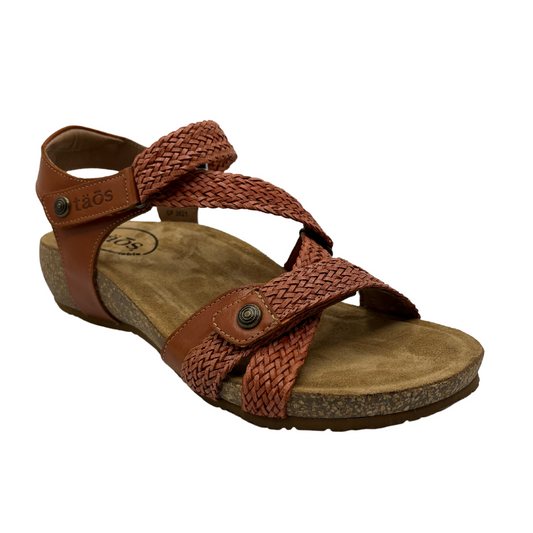 45 degree angled view of braided leather strapped sandal with contoured cork footbed covered with suede