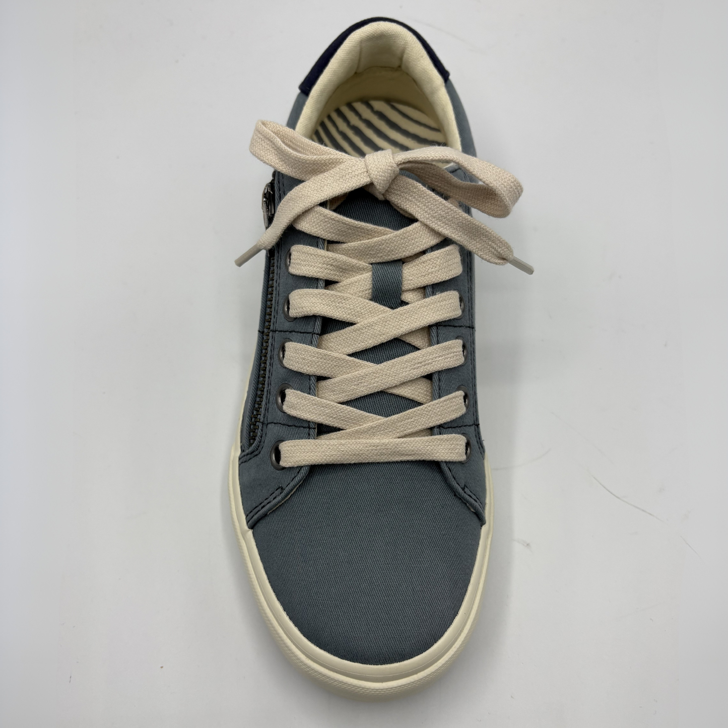 Gray sneaker with beige laces on a white background