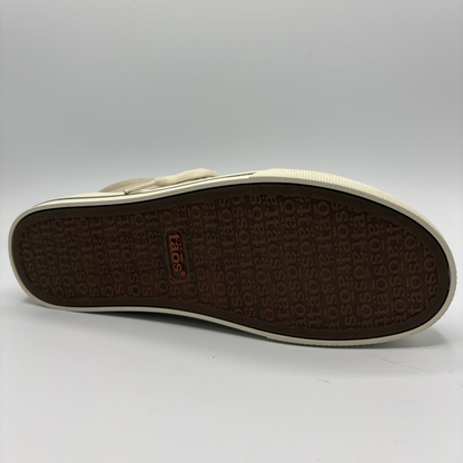 Close-up of a shoe sole with brand logo on a gray background