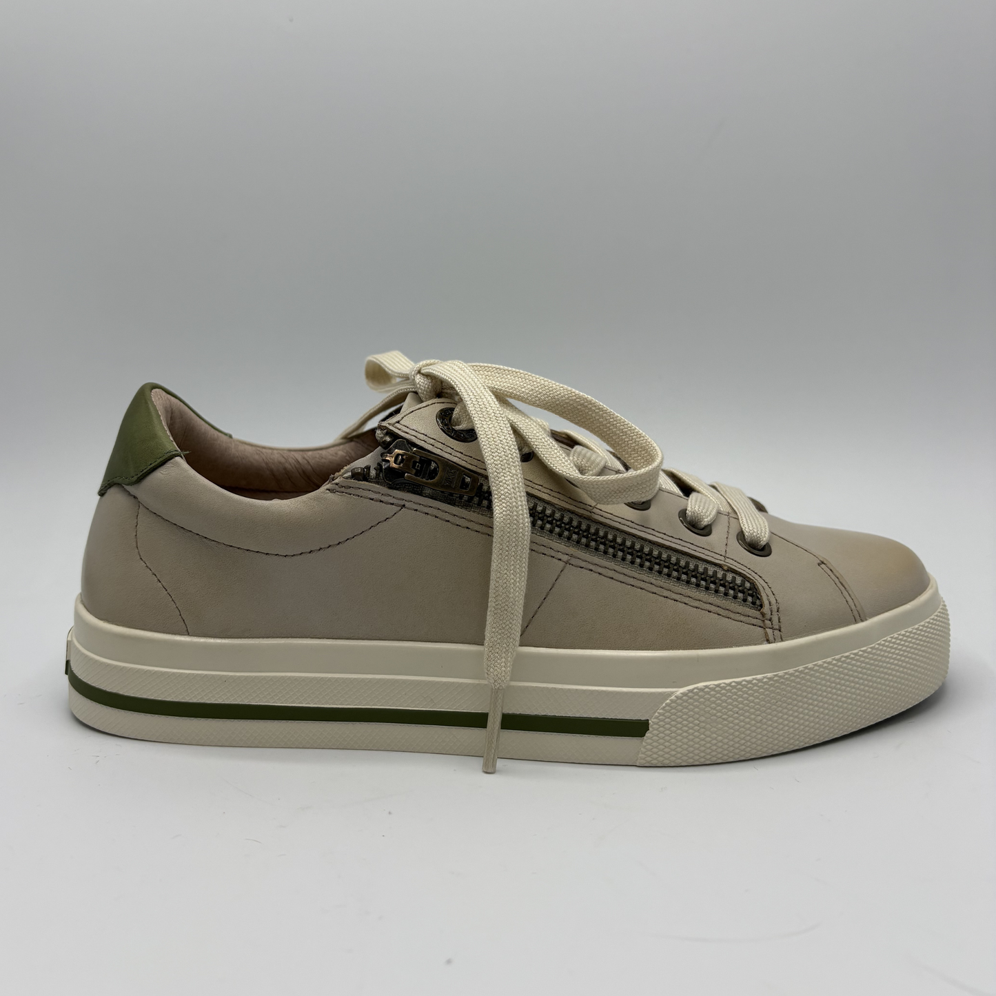 Beige sneaker with a zipper on a gray background
