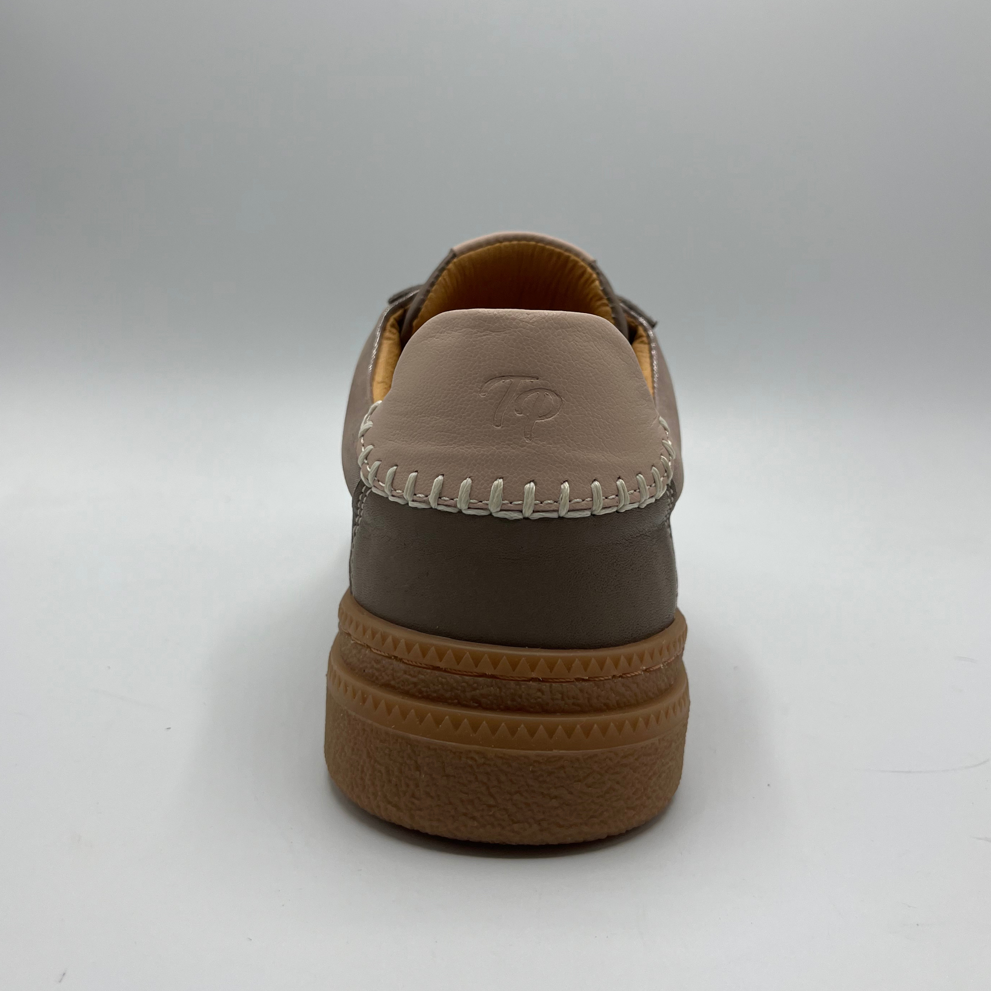 Brown shoe with a visible brand logo on a white background