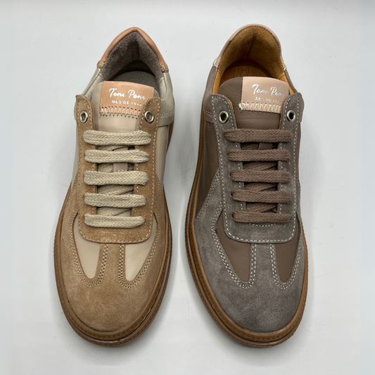 Pair of brown and gray sneakers on a light gray background