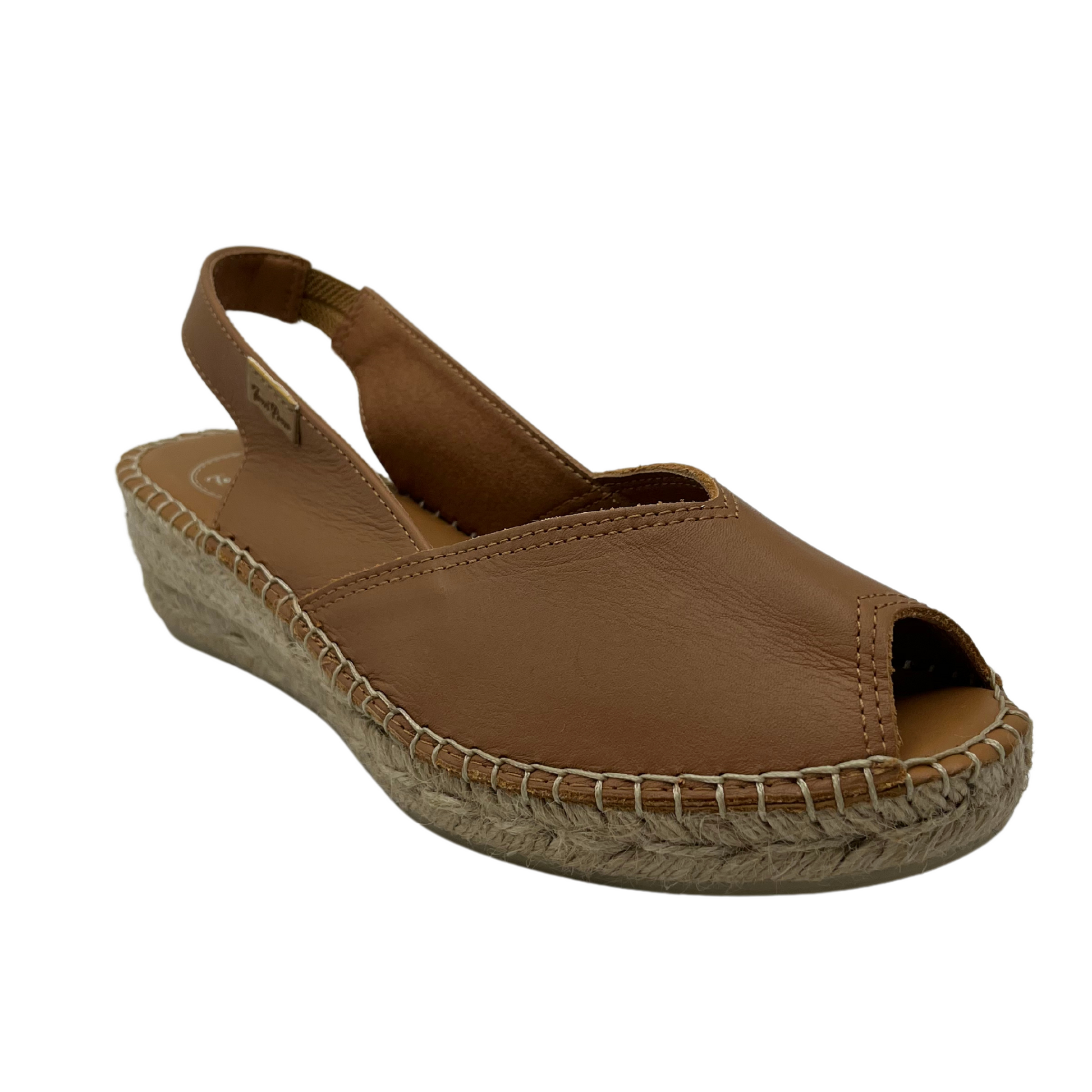 45 degree angled view of tan leather wedge espadrille