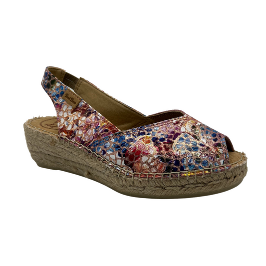 45 degree angled view of colourful leather upper espadrille shoe with sling back strap and slight wedge heel.