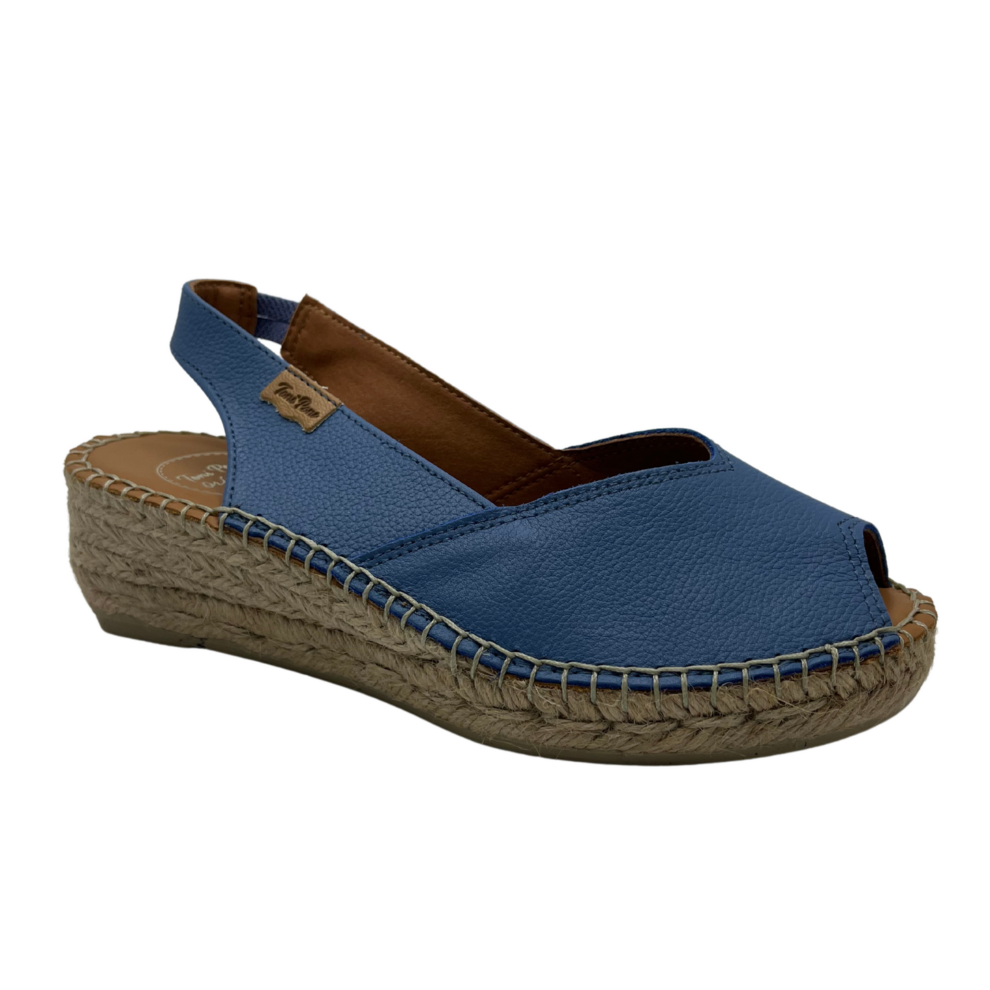 Angled front view of a whte espadrille sandal with a peep toe opening and heel strap. Shown in denim