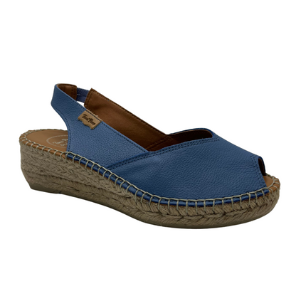 Angled front view of a whte espadrille sandal with a peep toe opening and heel strap. Shown in denim