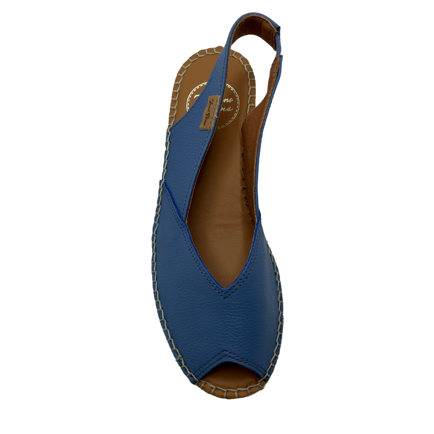 Top view of a whte espadrille sandal with a peep toe opening and heel strap. Shown in denim