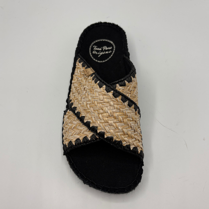 Woven sandal with black trim on a light gray background