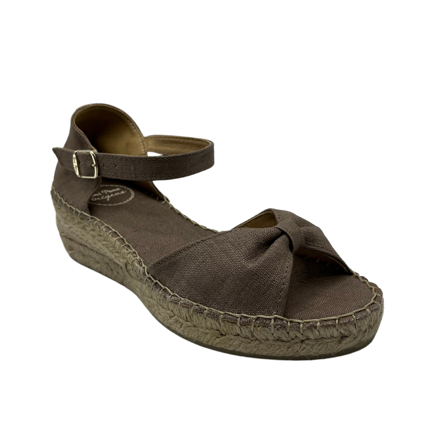 45 degree angled view of taupe sandal with low wedge heel and bow strap on toe