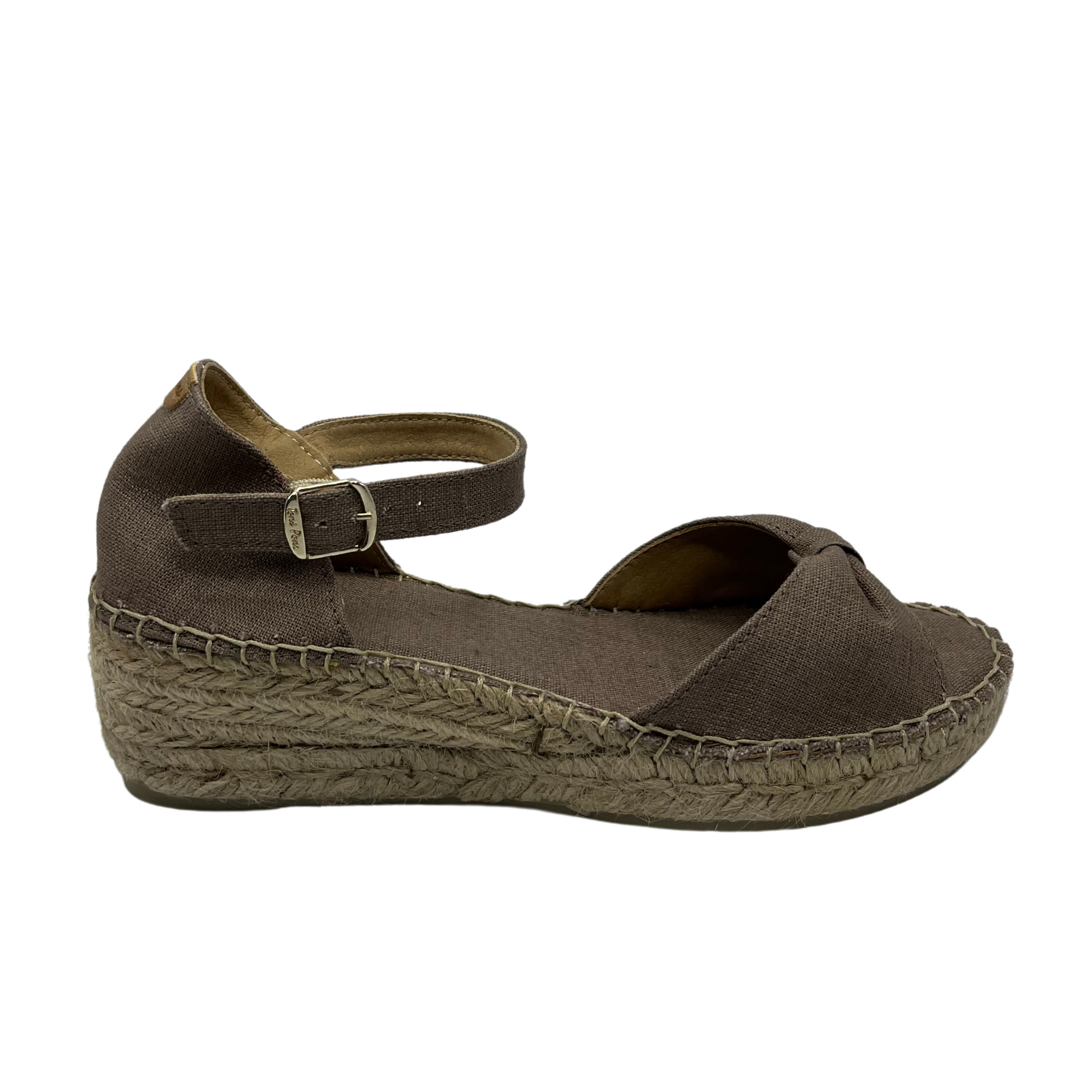 Right facing view of taupe wedge sandal with bow strap on toe and buckle ankle strap