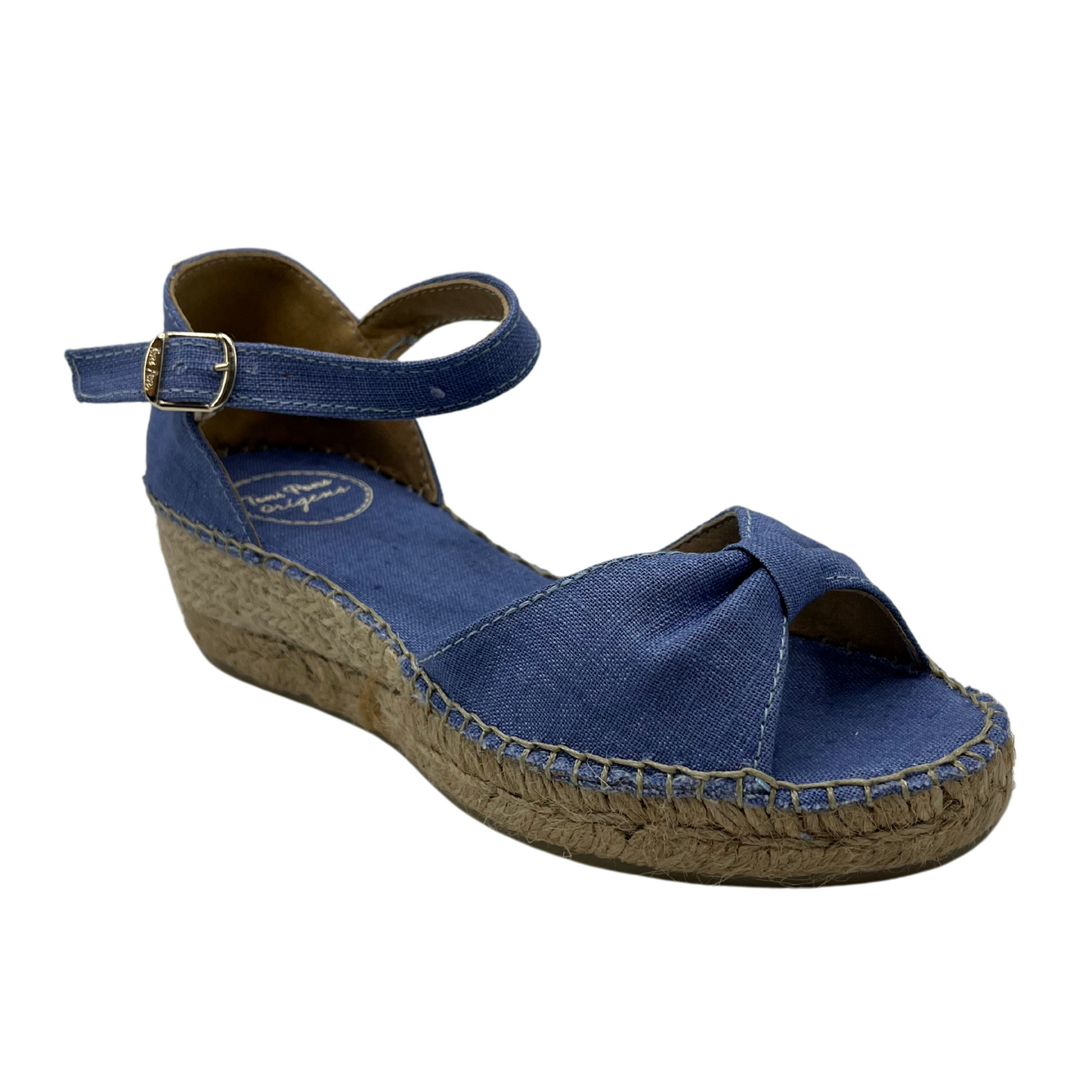 45 degree angled view of blue low wedge sandal with bow strap on toe and buckle strap on ankle