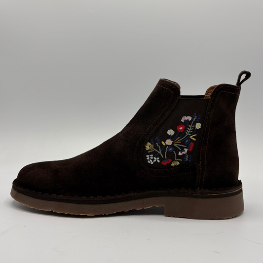 A dark brown suede Chelsea boot with colorful floral embroidery on the side, shown in profile against a neutral gray background.
