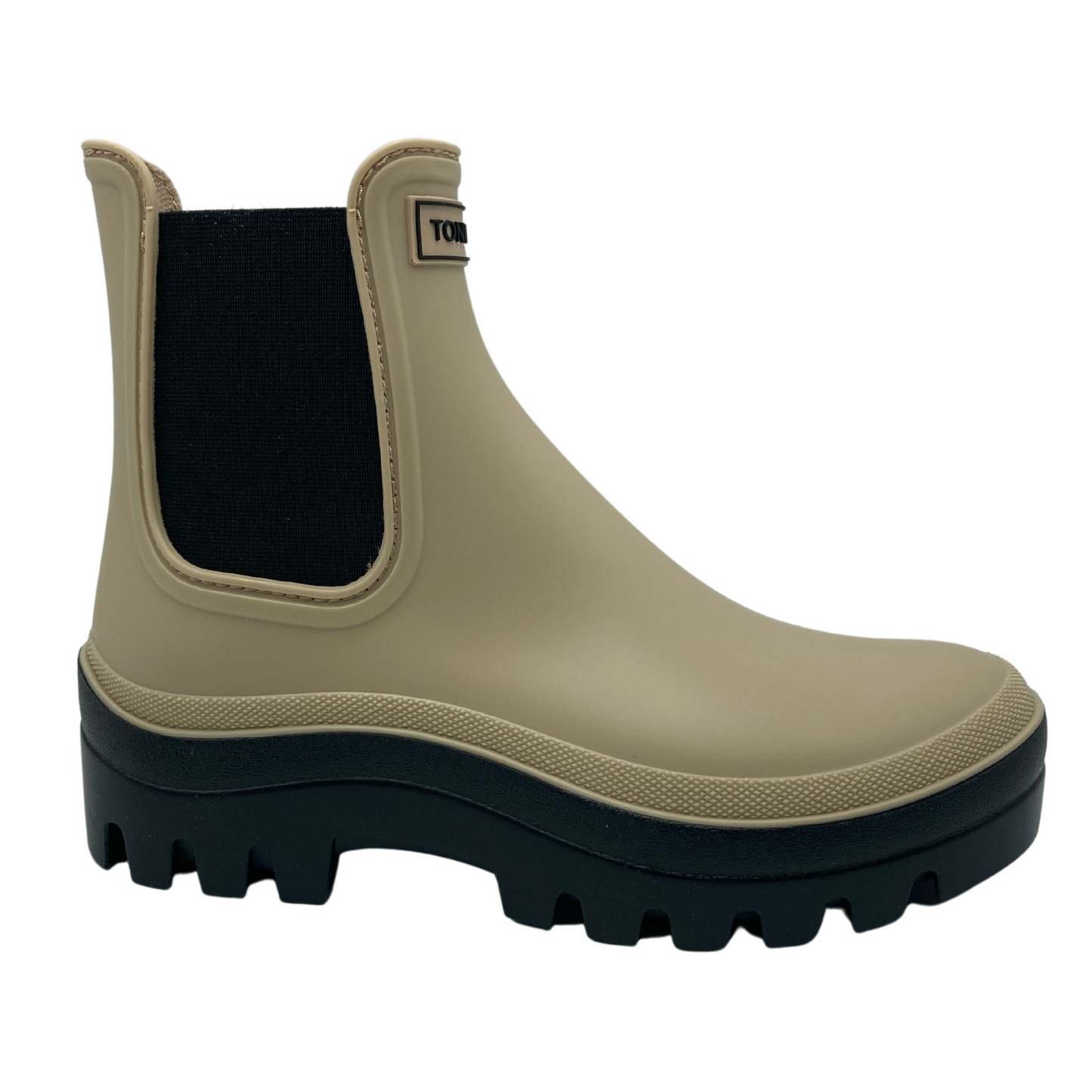 Right facing view of beige rubber chelsea boot with black platform sole and elastic sides