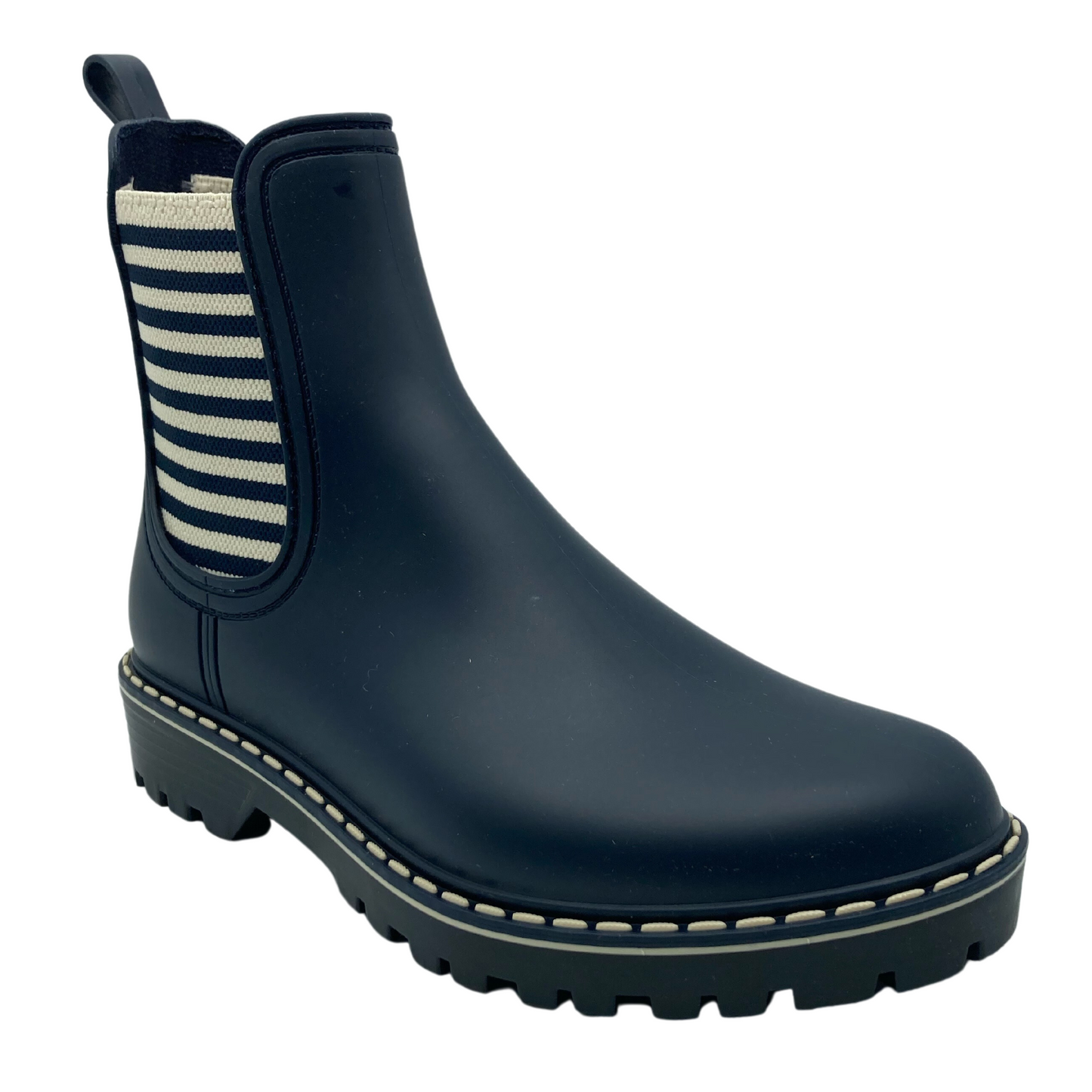 45 degree angled view of navy short boot with white and navy elastic side panel and black rubber outsole